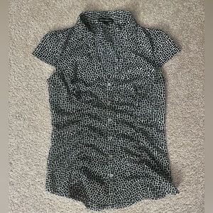 Express shirt. Snug fit. Very comfortable and flattering. Great for work!